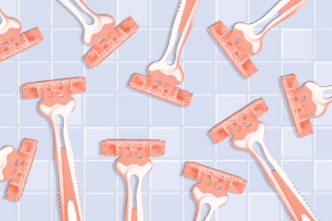 assortment of razors on a bathroom tile background