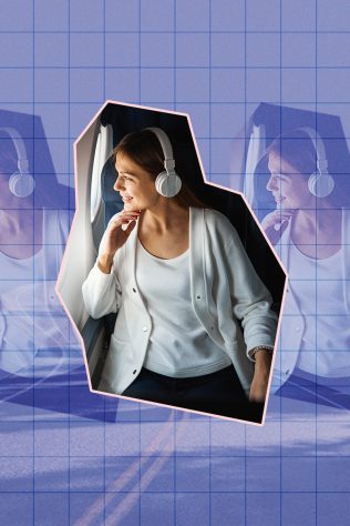 woman wearing headphones on plane with road